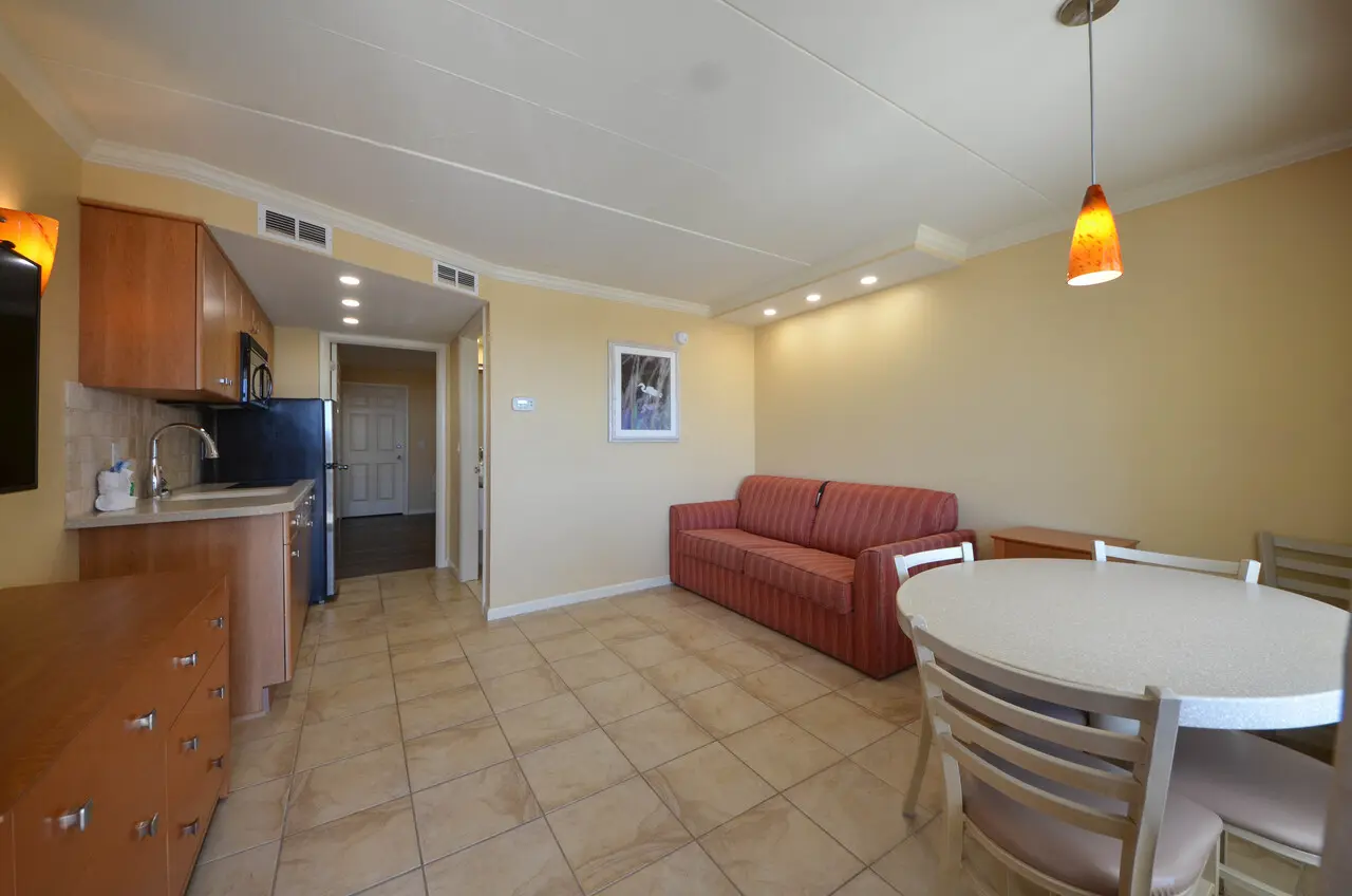 Kitchenette, dining table, and sitting area in a Type C efficiency suite