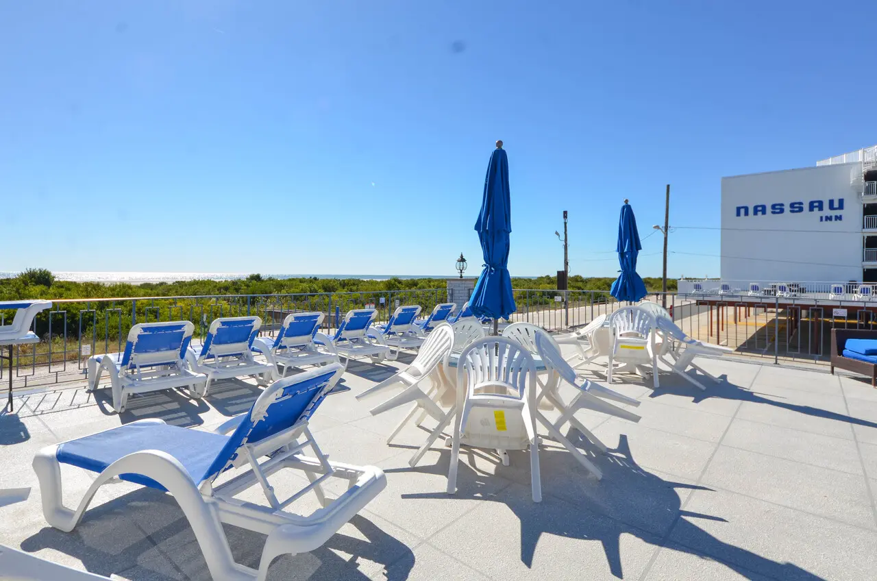 Blue lounge chairs and umbrellas on the resort’s oceanfront sundeck